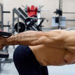 Man doing triceps exercise with dumbbells